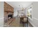 Open-concept dining area features a brick fireplace and flows into the kitchen at 4041 Wendy Ln, Zebulon, NC 27597