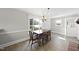 Dining room is well-lit from window and chandelier with view of outdoor scenery at 4041 Wendy Ln, Zebulon, NC 27597