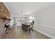 Well-lit dining room with brick fireplace, chandelier, and view into the kitchen at 4041 Wendy Ln, Zebulon, NC 27597