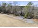 Charming home with a long driveway surrounded by mature trees and landscaping at 4041 Wendy Ln, Zebulon, NC 27597