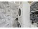 A conveniently stacked washer and dryer in a room with patterned wallpaper at 4041 Wendy Ln, Zebulon, NC 27597
