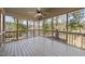 Spacious screened porch with ceiling fan and wooden floors overlooks a tranquil wooded view at 4041 Wendy Ln, Zebulon, NC 27597