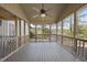 Large screened porch features a ceiling fan and expansive views of the surrounding woods at 4041 Wendy Ln, Zebulon, NC 27597