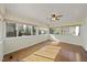 Bright and airy sunroom with lots of windows, wood flooring and a ceiling fan at 4041 Wendy Ln, Zebulon, NC 27597