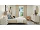 Bright bedroom design with a window, textured rug, soft decor and contemporary furnishings at 406 Queenstown Drive # 24, Kenly, NC 27542