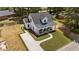 Aerial view of home showcasing landscaped yard, driveway, and a charming covered front porch at 412 N Green St, Selma, NC 27576