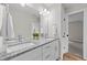 Bathroom featuring double sinks and a granite countertop and modern fixtures at 412 N Green St, Selma, NC 27576