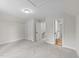 Bedroom with neutral carpet, recessed lighting, and multiple access doors at 412 N Green St, Selma, NC 27576