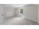 Neutral-colored bedroom with a view through a window and ample closet space at 412 N Green St, Selma, NC 27576