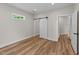 Bedroom with wood-look floors, sliding barn door, and access to another room at 412 N Green St, Selma, NC 27576