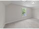 Bedroom with large window offers a view of the trees and yard at 412 N Green St, Selma, NC 27576