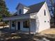 Charming white two-story home with a welcoming front porch and black trim windows at 412 N Green St, Selma, NC 27576