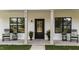 Charming front porch with a black front door flanked by rocking chairs and planters at 412 N Green St, Selma, NC 27576