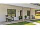 Charming front porch with rocking chairs and plants flanking the home's front door at 412 N Green St, Selma, NC 27576