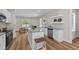 Modern kitchen featuring stainless steel appliances, white cabinets, and center island with barstool seating at 412 N Green St, Selma, NC 27576