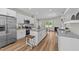 Bright kitchen features white cabinets, granite countertops, stainless appliances, and wood flooring at 412 N Green St, Selma, NC 27576