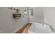 Bright laundry room with a hanging canvas bag and a large sink at 412 N Green St, Selma, NC 27576