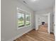 Bright living room featuring wood-look floors and view of front yard at 412 N Green St, Selma, NC 27576