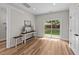 Bright living room with a console table, wood-look floors, and sliding glass door to backyard at 412 N Green St, Selma, NC 27576