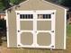 Close up of the double doors on the side shed with white trim and black hardware at 412 N Green St, Selma, NC 27576