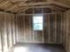 Spacious shed interior with wood walls and a window for natural light at 412 N Green St, Selma, NC 27576