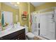 Bathroom with walk-in shower, sink, toilet, dark brown cabinets and yellow walls at 434 Golden Villas Dr, Rocky Mount, NC 27809