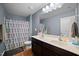 Bathroom features dual sinks, dark wood cabinets, and a shower with a decorative curtain at 434 Golden Villas Dr, Rocky Mount, NC 27809