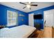 Bedroom with a large window, natural light, ceiling fan and TV creates a serene retreat at 434 Golden Villas Dr, Rocky Mount, NC 27809