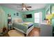 Well-lit bedroom featuring a ceiling fan and a large window for plenty of natural light at 434 Golden Villas Dr, Rocky Mount, NC 27809