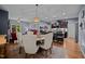 Open-concept dining area with hardwood floors, connected to the kitchen and living space with a backyard view at 434 Golden Villas Dr, Rocky Mount, NC 27809