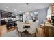 Well-lit dining area with seating and view of the kitchen, featuring dark cabinets and stainless steel appliances at 434 Golden Villas Dr, Rocky Mount, NC 27809