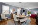 Cozy dining area with a round table, upholstered chairs, and views into the living room and backyard at 434 Golden Villas Dr, Rocky Mount, NC 27809