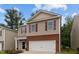 Two-story house with neutral siding, brick details, a two-car garage, and a well-kept lawn at 434 Golden Villas Dr, Rocky Mount, NC 27809