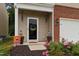 Charming front porch with seasonal decorations, flower pots, and a decorative wreath on the front door at 434 Golden Villas Dr, Rocky Mount, NC 27809