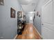 Hallway with hardwood floors, shelving and a view of the staircase and front door, offering a welcoming entrance at 434 Golden Villas Dr, Rocky Mount, NC 27809