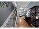 Inviting hallway with hardwood floors, staircase, and decorative shelving leading to an open dining area at 434 Golden Villas Dr, Rocky Mount, NC 27809
