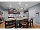 Kitchen island with stainless steel appliances, sink, faucet, dark brown cabinets and granite countertops at 434 Golden Villas Dr, Rocky Mount, NC 27809