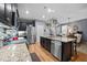 Modern kitchen with a granite island, stainless steel appliances, and open view to dining area at 434 Golden Villas Dr, Rocky Mount, NC 27809