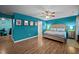 A spacious main bedroom featuring blue walls and laminate wood flooring at 434 Golden Villas Dr, Rocky Mount, NC 27809