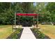 Landscaped backyard featuring pergola with seating surrounded by lush greenery at 434 Golden Villas Dr, Rocky Mount, NC 27809