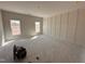 Bright bedroom with board and batten accent wall and natural light from two windows at 45 Trescott St, Smithfield, NC 27577