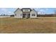 Exterior view of home featuring a screened in back porch and large backyard at 4840 Baines Loop Rd, Spring Hope, NC 27882