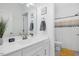A stylish bathroom with white cabinets, a sleek mirror, and a shower with patterned curtain at 4840 Baines Loop Rd, Spring Hope, NC 27882