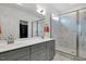 Modern bathroom with dual sinks, white countertops, grey cabinets, and a glass-enclosed shower with tile surround at 4840 Baines Loop Rd, Spring Hope, NC 27882
