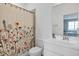 Clean bathroom featuring floral shower curtain, white fixtures, and a large mirror at 4840 Baines Loop Rd, Spring Hope, NC 27882