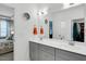 Bright bathroom with double vanity, grey cabinets, modern fixtures, and a view of the walk-in closet at 4840 Baines Loop Rd, Spring Hope, NC 27882