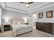 Nicely decorated bedroom features a ceiling fan, dresser, and a comfortable bed with decorative pillows at 4840 Baines Loop Rd, Spring Hope, NC 27882