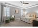 Spacious bedroom features a decorative ceiling fan, a cozy seating area, and a comfortable queen-size bed at 4840 Baines Loop Rd, Spring Hope, NC 27882
