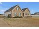Beautiful home featuring brick and siding, complemented by a well-manicured lawn and lush greenery at 4840 Baines Loop Rd, Spring Hope, NC 27882