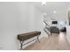 Bright foyer with hardwood floors, elegant console table, and open staircase leading to the living area at 4840 Baines Loop Rd, Spring Hope, NC 27882